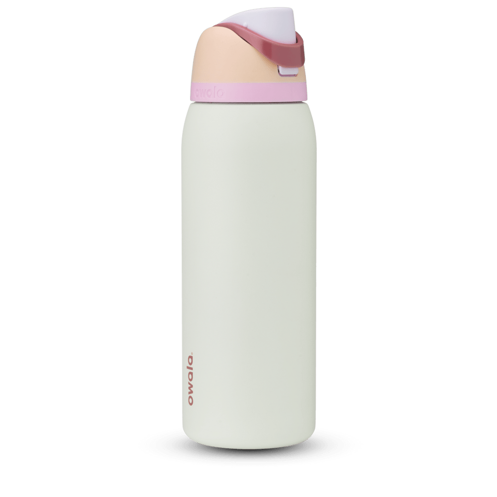 Owala FreeSip 24oz in Out of the Blue, periwinkle blue insulated bottle with matching blue-lavender flip cap and carry loop