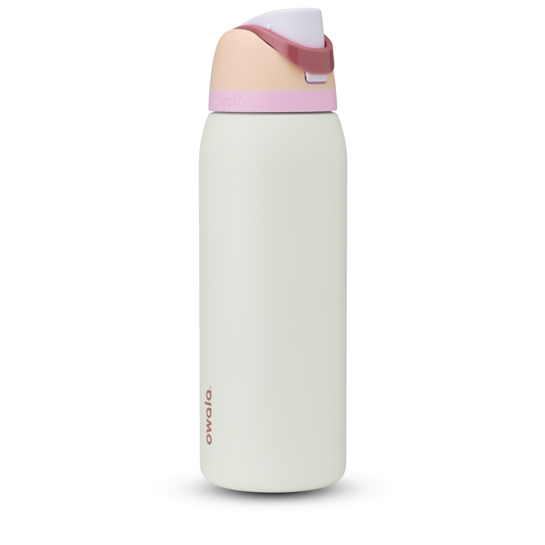 Owala FreeSip 24oz in Out of the Blue, periwinkle blue insulated bottle with matching blue-lavender flip cap and carry loop
