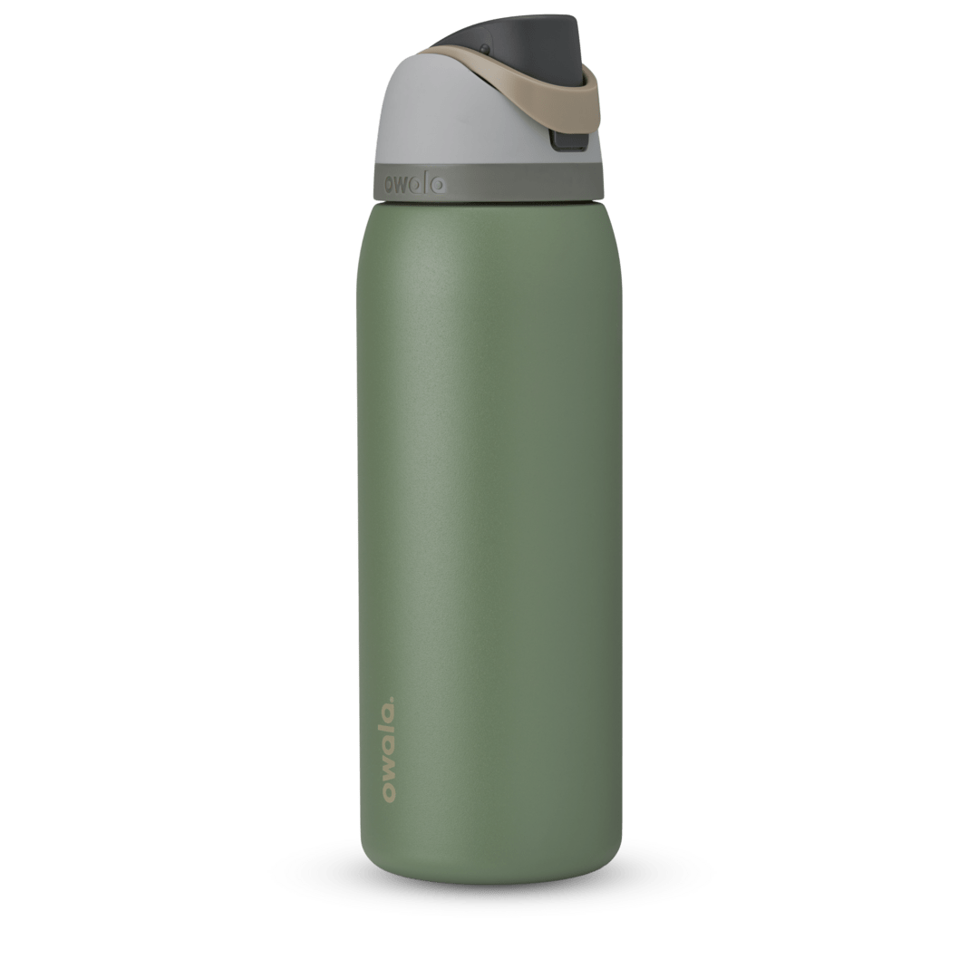 Owala FreeSip 24oz in Out of the Blue, periwinkle blue insulated bottle with matching blue-lavender flip cap and carry loop