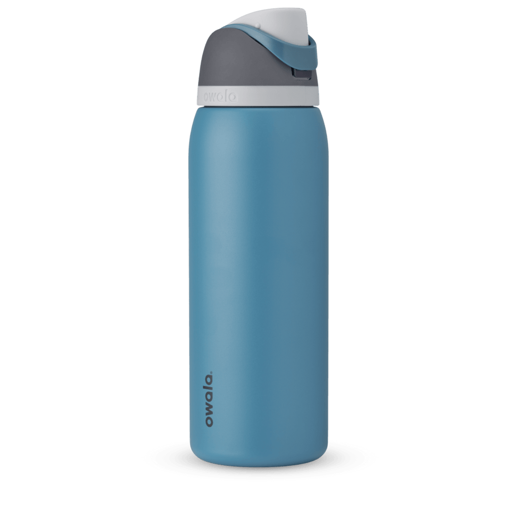 Owala FreeSip 24oz in Out of the Blue, periwinkle blue insulated bottle with matching blue-lavender flip cap and carry loop
