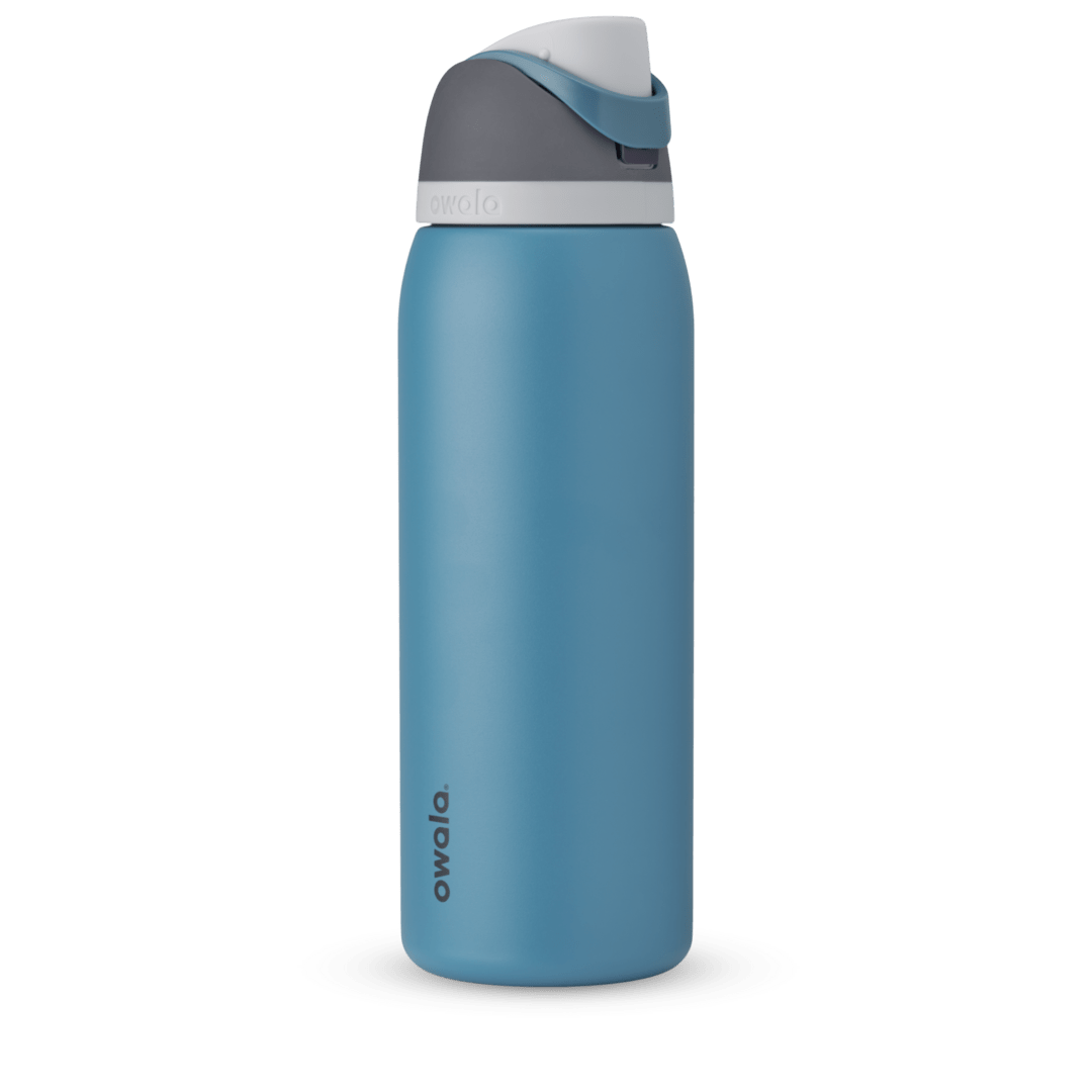 Owala FreeSip 24oz in Out of the Blue, periwinkle blue insulated bottle with matching blue-lavender flip cap and carry loop