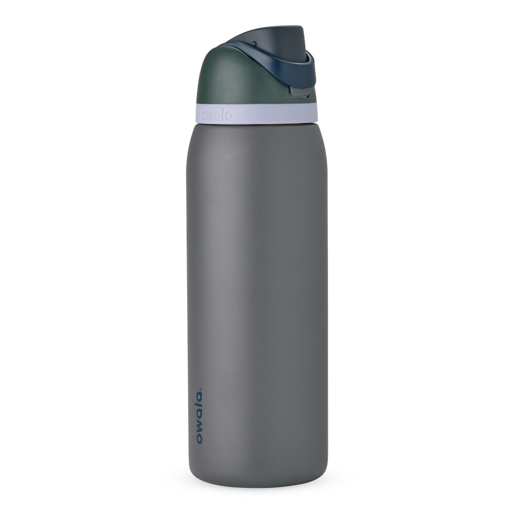 Owala FreeSip 24oz in Out of the Blue, periwinkle blue insulated bottle with matching blue-lavender flip cap and carry loop